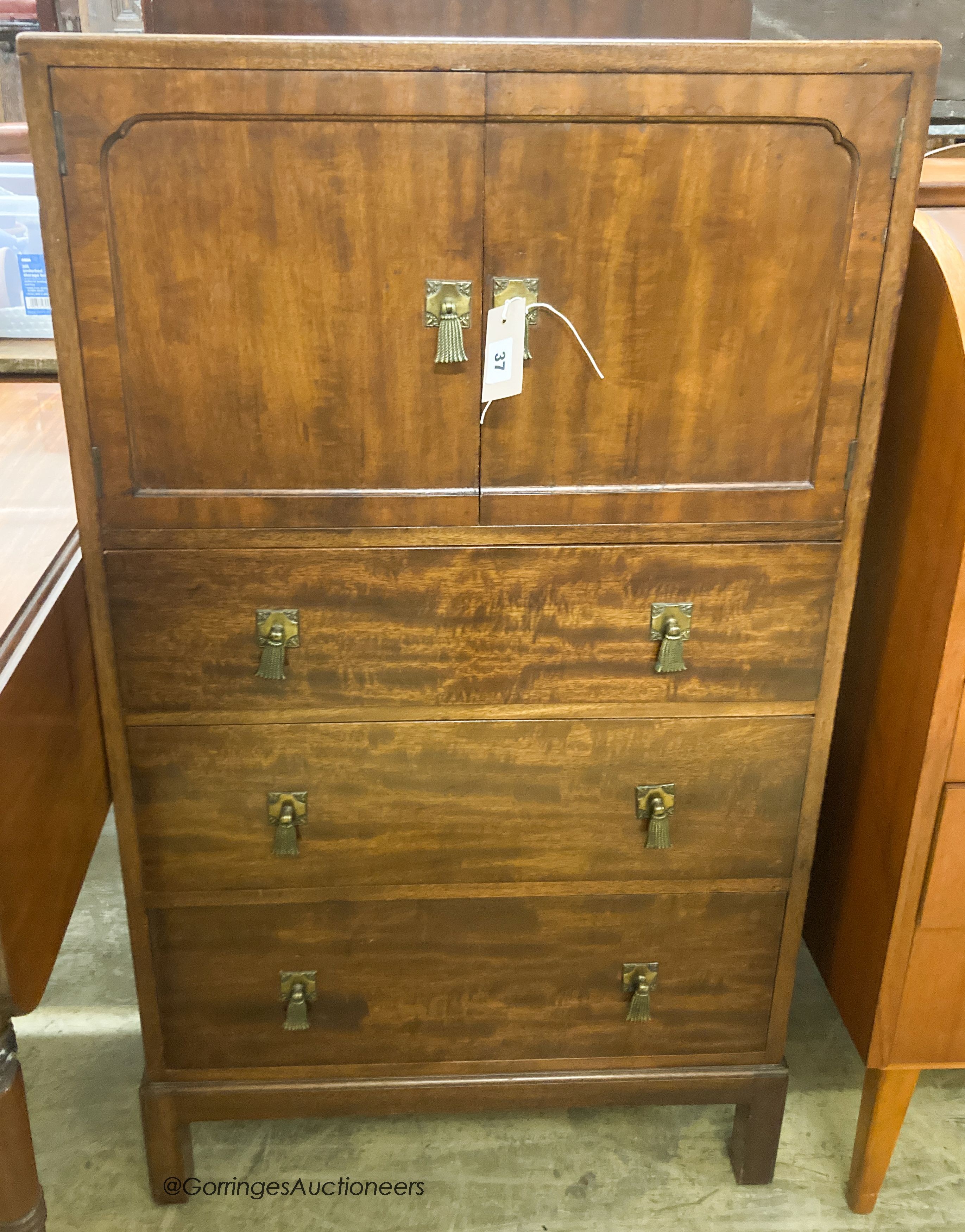 A 1920's mahogany three drawer side cabinet, stamped Waring & Gillow, W.61cm D.44cm H.110cm